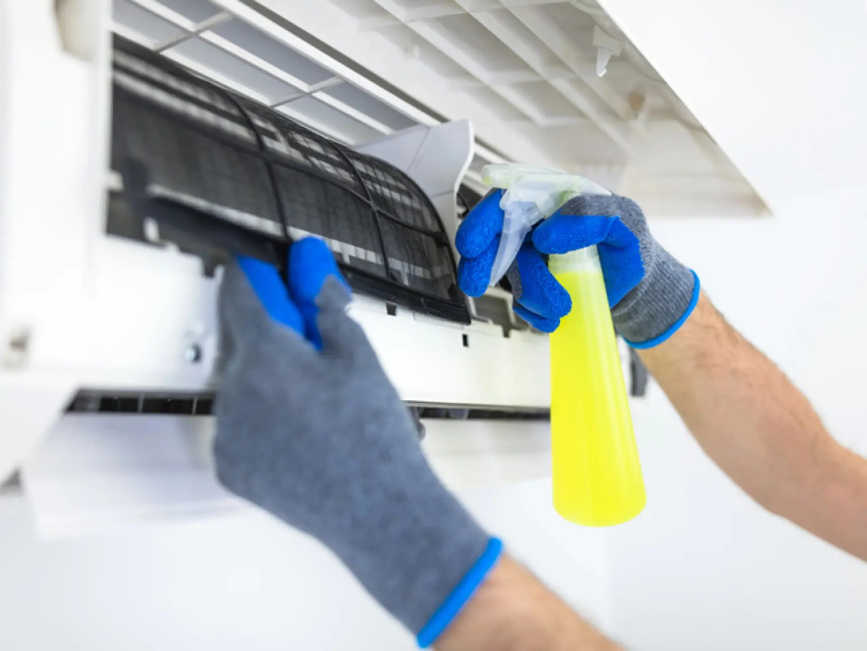 Limpieza profesional de filtros de aire acondicionado durante mantenimiento preventivo